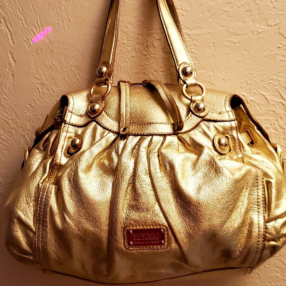 Moschino Gold Hobo Bag with Lustrous Finish and Decorative Hardware